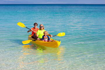 Kids kayaking in ocean. Family in kayak in tropical sea
