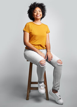 Portrait, Smile And Woman Sitting On Stool In Studio Isolated On A White Background. Chair, Confidence And Happy African Female Person From South Africa With Stylish Fashion, Gen Z Or Trendy Clothing