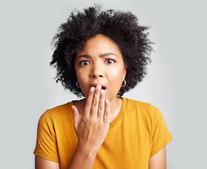 Surprise, wow and woman covering mouth with hand isolated on a white background in studio. Shocked, face and African female person amazed, omg or surprised reaction to news, emoji or fear portrait