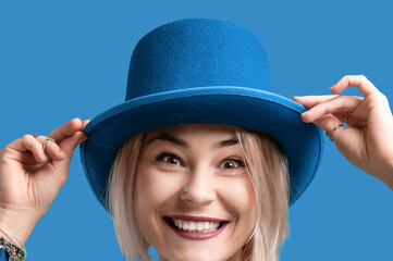 Smiling woman. Beautifu young woman wearing blue hat and in a blue sweatshirt. Young woman with beautiful smile happy and excited.
