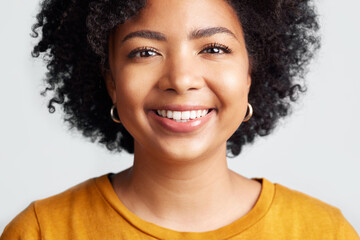 Happy, woman and portrait of face in studio, white background and backdrop. Confident young african female model smile for natural curly afro hair, positive personality and gen z girl of South Africa