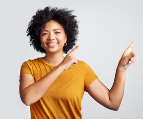 Portrait of happy woman, advertising and pointing to studio offer, information and brand coming soon. African female model gesture to announcement, sales promotion or presentation on white background