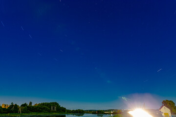 Background Of Stars Traces Revolving Around By Circular Trails Against Night Sky.