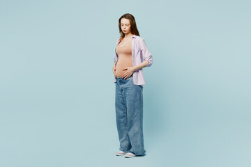 Full body side view sad young pregnant future mom woman with belly tummy with baby wearing casual...