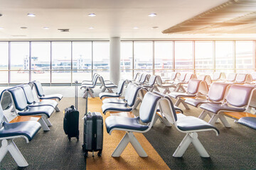 Row of seat bench in airport.Empty metallic chairs in airport. Waiting room furniture. Airport departure or arrival with luggage or baggage. Passenger seat with light from window.Travel on holiday.