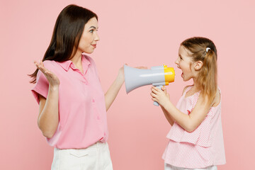 Happy woman wear casual clothes with child kid girl 6-7 years old. Mother daughter hold megaphone...