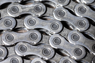Extreme Closeup View of Used Dirty Greasy Oiled Bicycle Chain As A Part of Metal Bicycle Equipment On Stony Background With Contrast Details