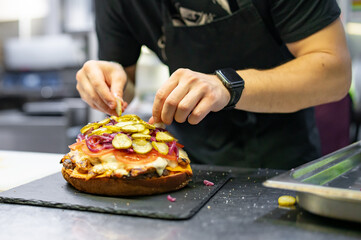 chef hand cooking big large cheese burger on restaurant kitchen. step by step