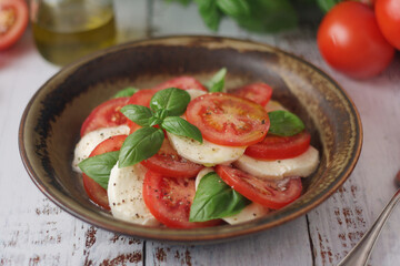 A bowl with traditional Italian caprese salad	