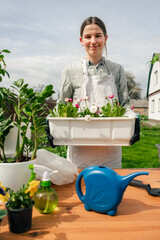 a beautiful caucasian woman planting flowers in pots