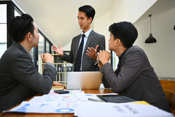 Businesspeople shearing idea, discussing corporate business plan together at modern office