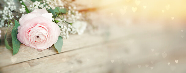 Beautiful bouquet of spring flowers with bokeh hearts on rustic wooden board - greeting card for mothers day, birthday , wedding greeting card