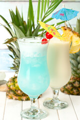 Blue Lagoon and pina colada cocktail on the table