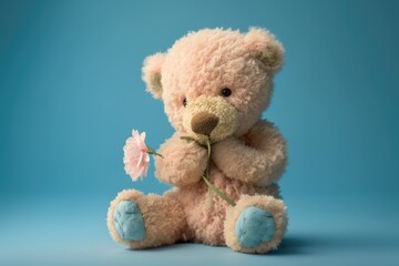 Cute teddy bear holding a pink rose on a blue background. Isolated. 