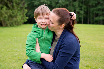 Fototapeta na wymiar Mom and son are playing in the park. Cheerful happy family having a picnic. Vacations and trips out of town in country.