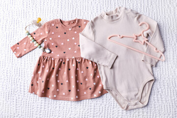 Baby girl clothes with pacifier and hanger