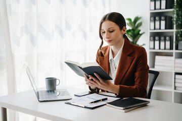  Business woman reading book while sitting at  n cafe or home office