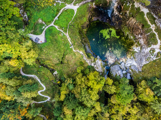 Autumn on the Karst waterfall of Fontanon di Goriuda. View from above.