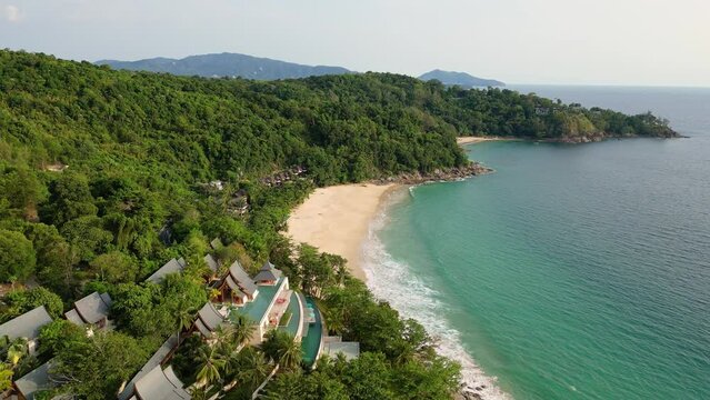Phuket, Thailand: Dramatic drone footage of the Nai Thon and Banana beaches in the Phuket tropical island lined with luxury real estate and resort in the Andaman sea in Thailand. 