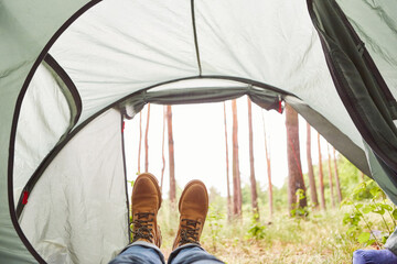 Senior man with brown shoes in camping tent