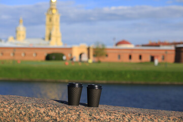 Russia, St. petersburg, 26.04.2023, two paper cups with coffee or tea in front of the Peter and...