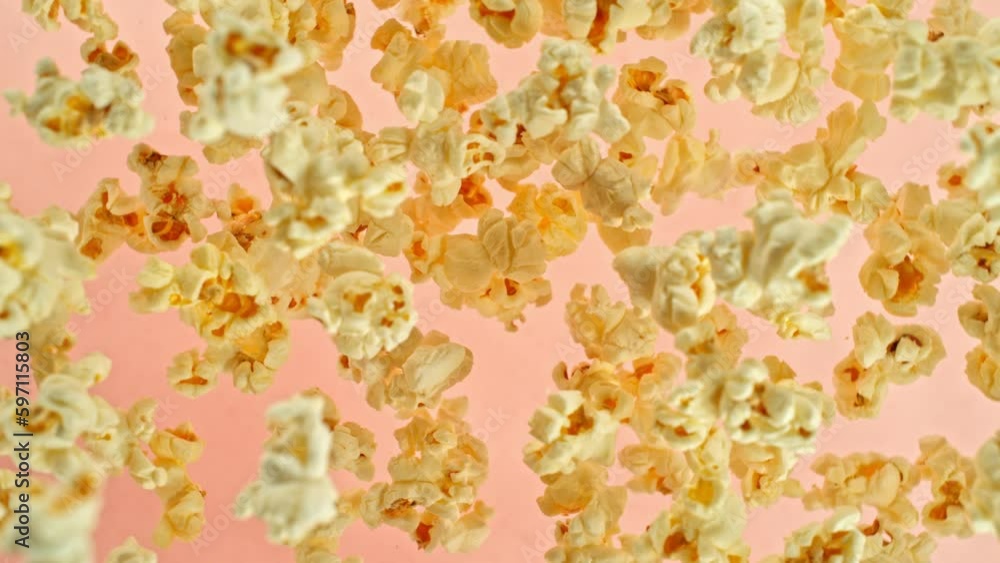 Poster super slow motion of rotating popcorn in the air. isolated on colored background. filmed on high spe