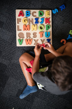 Young Aboriginal boy doing a letter puzzle