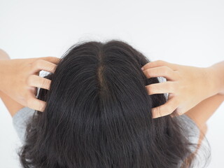 Fototapeta premium The kid girl head scratch caused by disease of the scalp, it is lice and fungus on the scalp. Shampoo product and medicine concept. Top view photo, blurred.