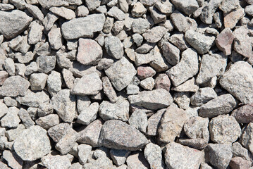 Abstract background with stones. Crushed stone texture background. Stone wall constructed by gray