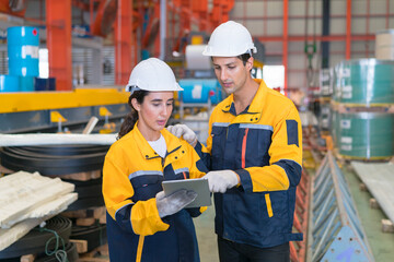 Professional heavy industry engineer worker wearing safety uniform in a metal manufacture warehouse , maintenance service check for safety first concept .