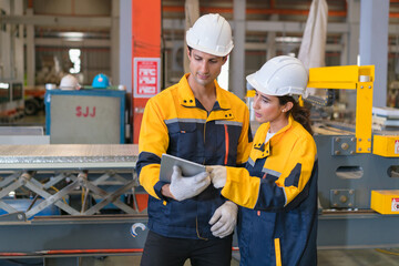 Professional heavy industry engineer worker wearing safety uniform in a metal manufacture warehouse , maintenance service check for safety first concept .