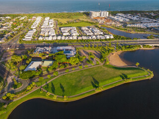 Aerial view of a parkland reserve and waterfront property around coastal canals