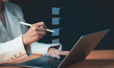 Businesswoman using laptop doing online checklist survey, Business performance checklist,  filling...