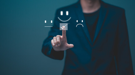 Customer service and Satisfaction concept, Businessman choosing on the happy Smile face icon to give satisfaction in service,  rating very impressed. review, feedback, best quality, good mood.