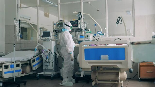 Healthcare worker taking care of a patient with coronavirus disease