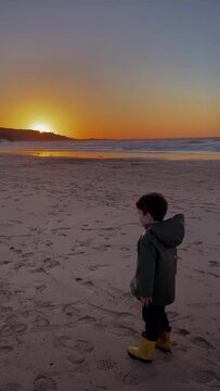 Small Boy on a beach at Sunset
