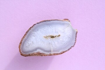 Natural violet amethyst druse geode mineral crystal polished semi-precious gemstone on purple...