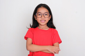 Obraz premium Asian kid smiling confident with arms crossed