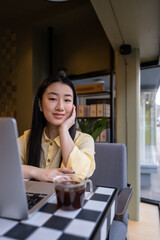 Tranquil freelancer seated at the laptop in a cafe