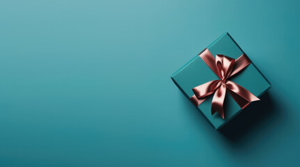 Obraz na płótnie Canvas Gift box with satin ribbon and bow on blue background. Holiday gift with copy space. Birthday or Christmas present, flat lay, top view. Christmas giftbox concept. Generative Ai