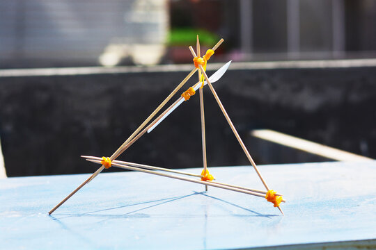 Handmade catapult from wooden sticks, elastics and a spoon.