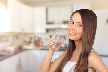 Young beautiful woman drink water at home