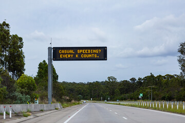 casual speeding? every k counts digital road sign above highway