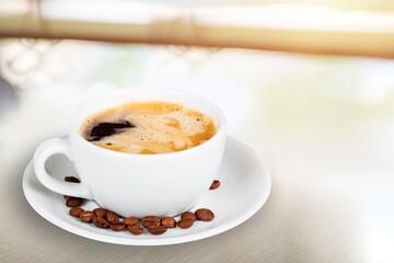 A cup of tasty aroma coffee on the desk.
