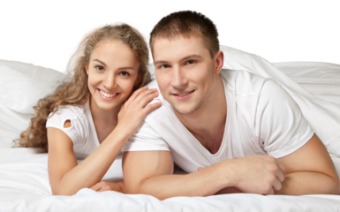 Young couple in bed isolated on white background