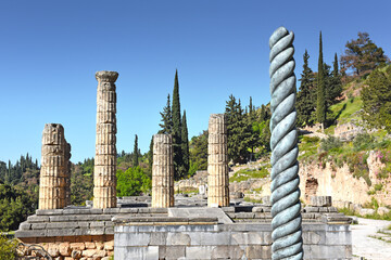 Serpent Column of Plataea or Delphi Tripod in front of the Temple of Apollo in Delphi, Greece, an...