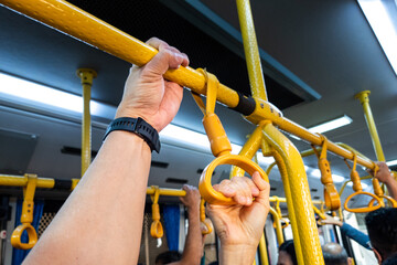 Hands holding handrails of public transport risk germs transmission and infections