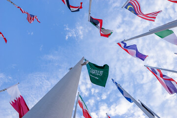 Doha, Qatar - April 25, 2023: Flags of countries in the old port of Doha, Qatar