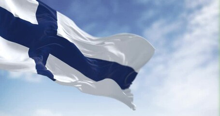 Seamless loop in slow motion of Finland national flag waving on a clear day