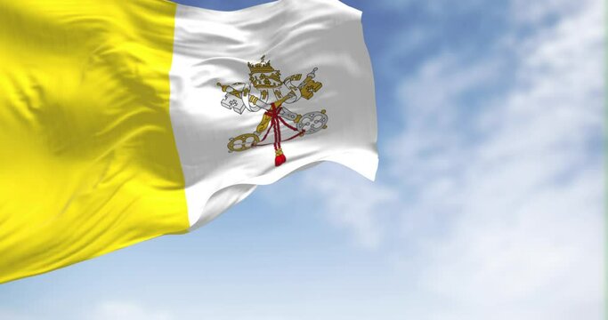 Seamless loop in slow motion of Vatican City flag waving on a clear day